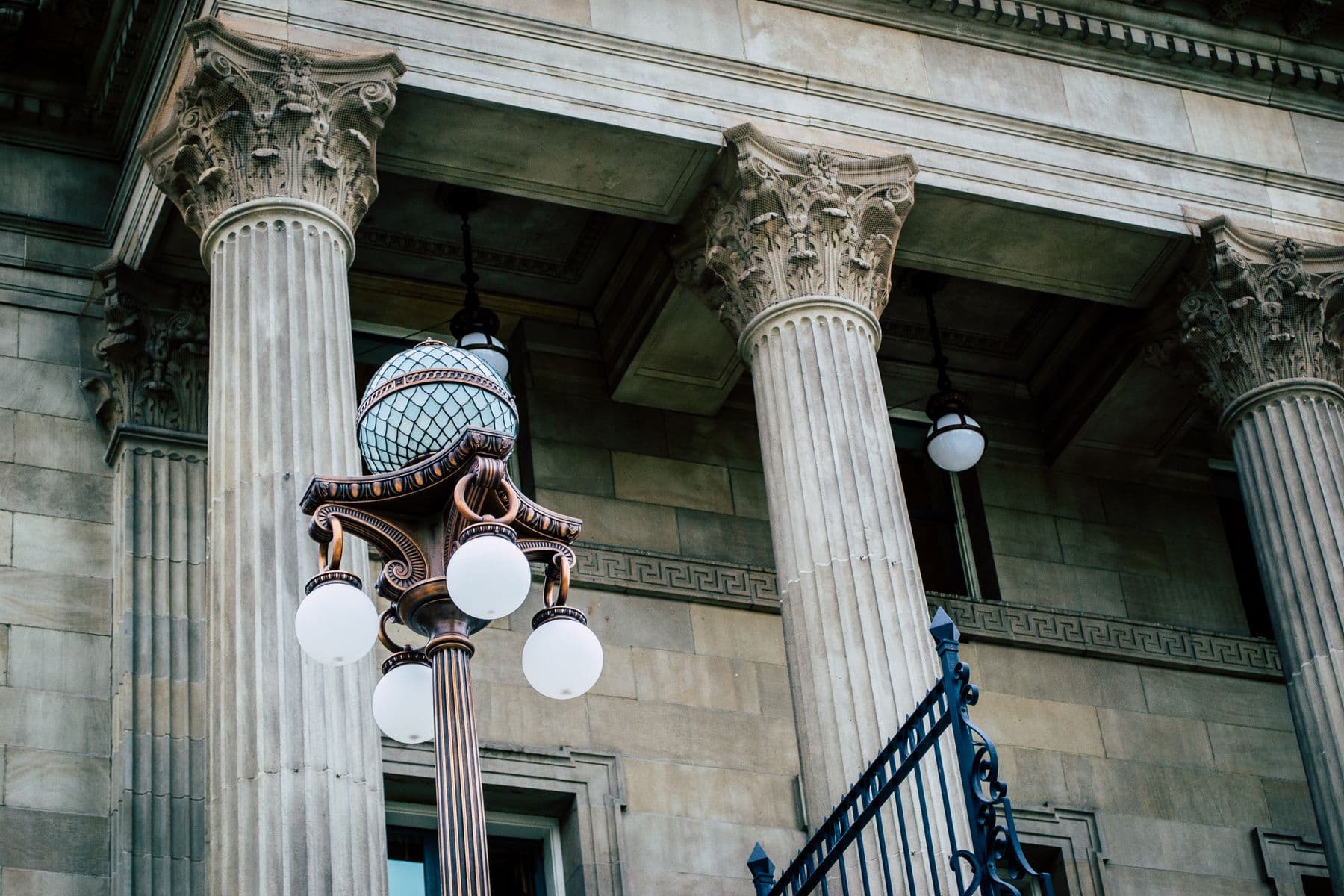 Stone columns and a lamp post at a neoclassical courthouse in Montreal