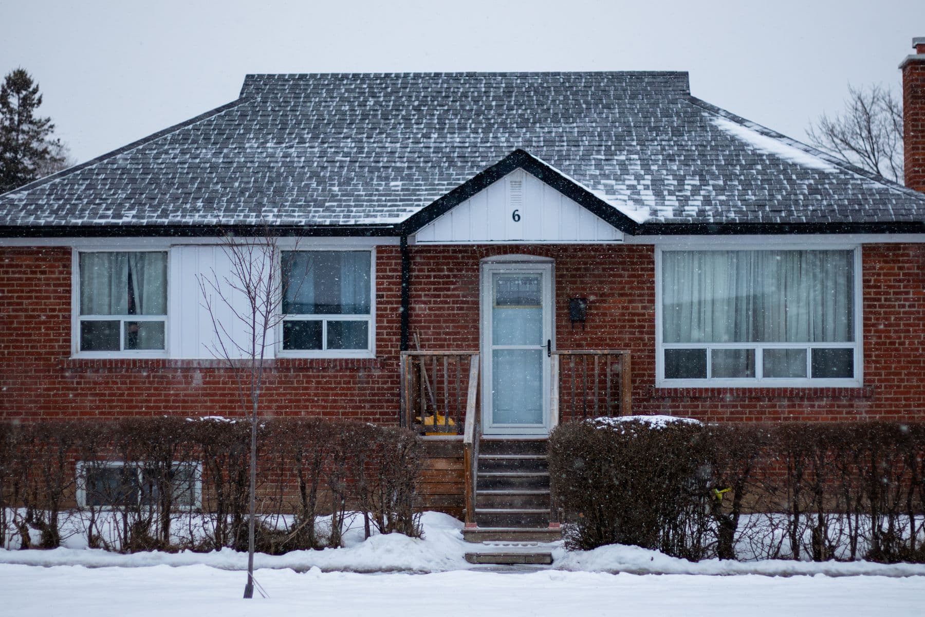 A snow-covered suburban brick house in Toronto in winter